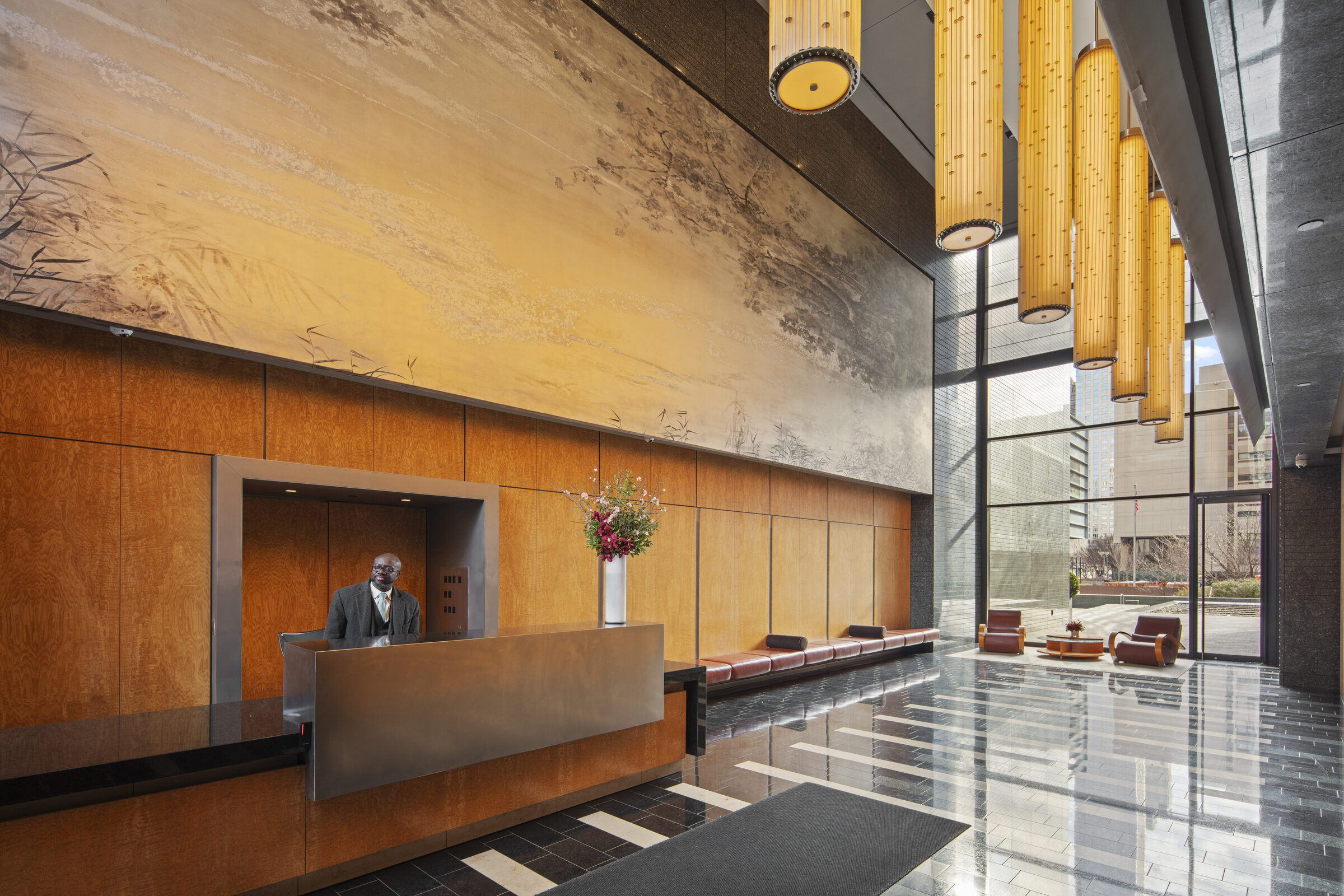 Warm wood reception lobby at AIRE with floor-to-ceiling windows