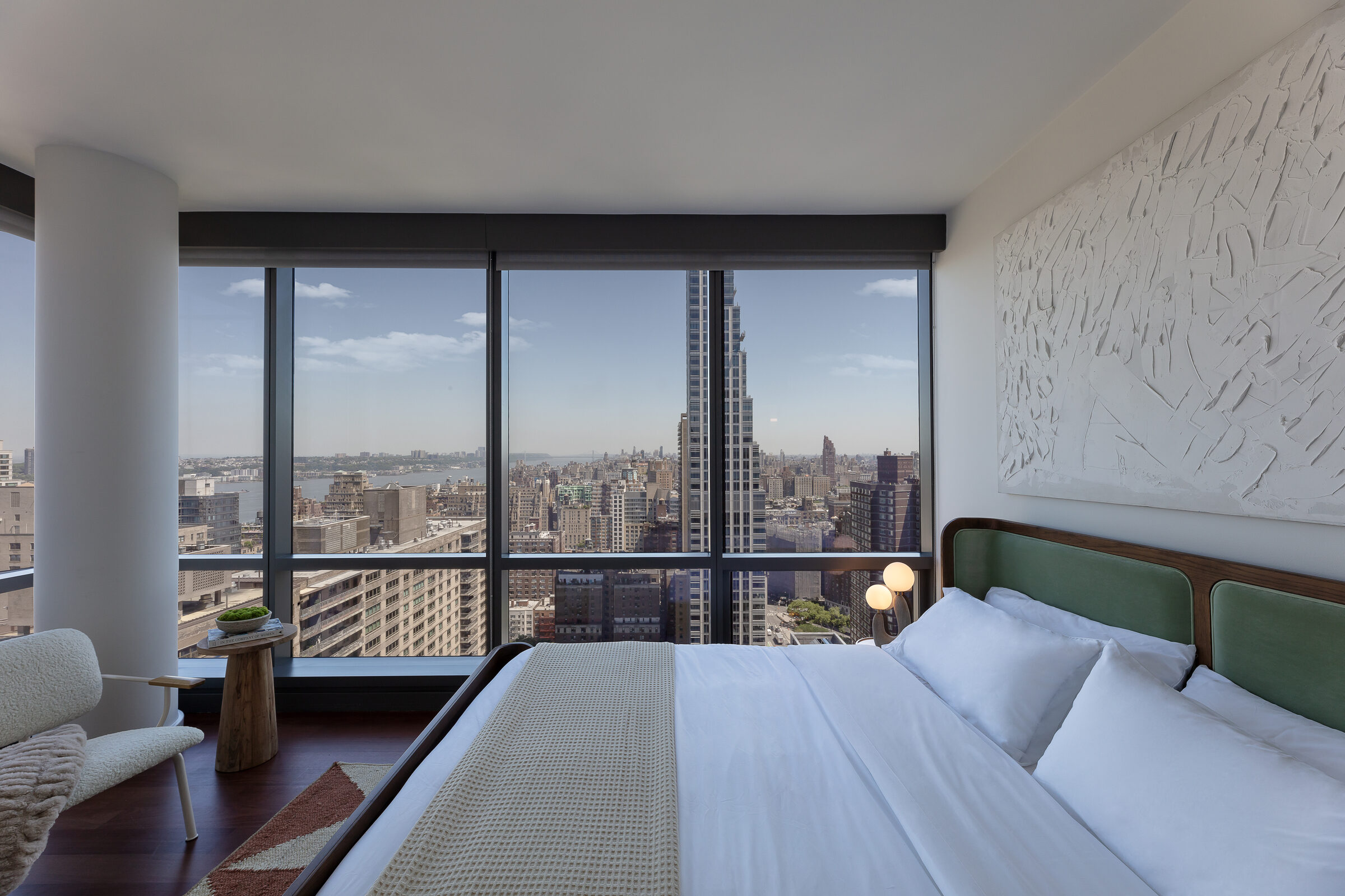 Bedroom at AIRE with floor-to-ceiling windows and panoramic city views