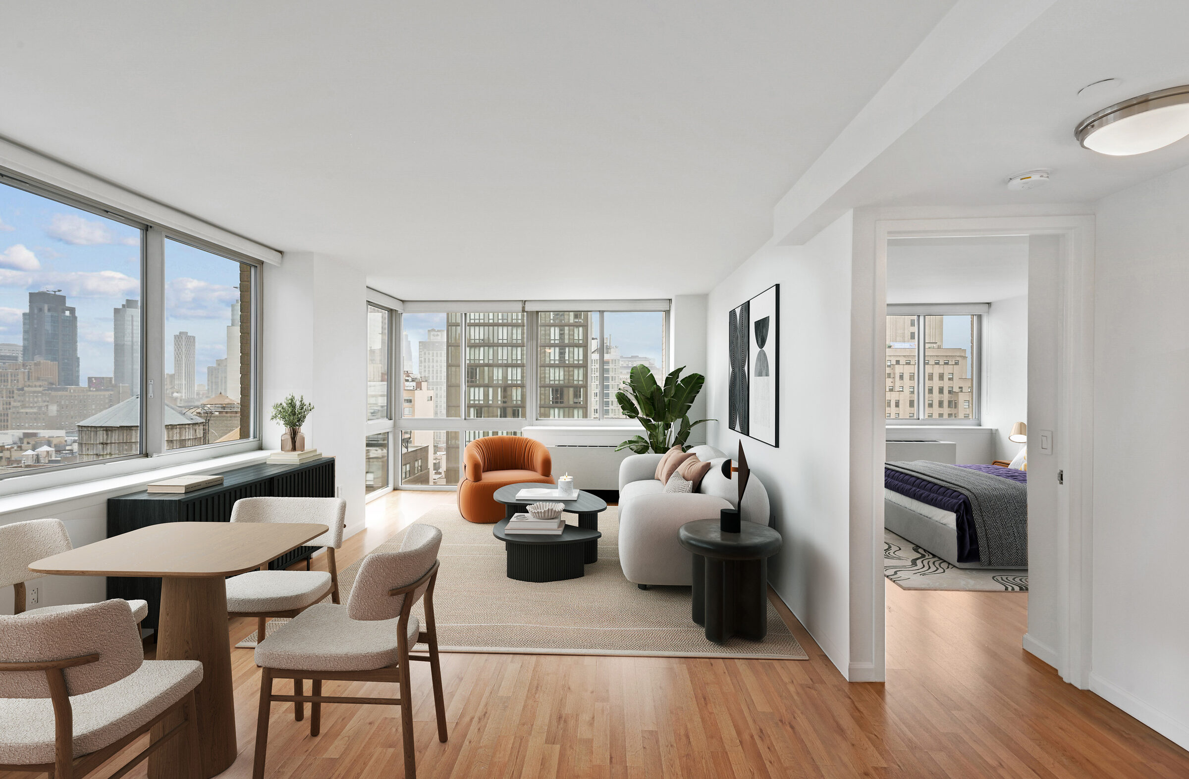 Open-plan living and dining room at Atlas New York with large windows and city views