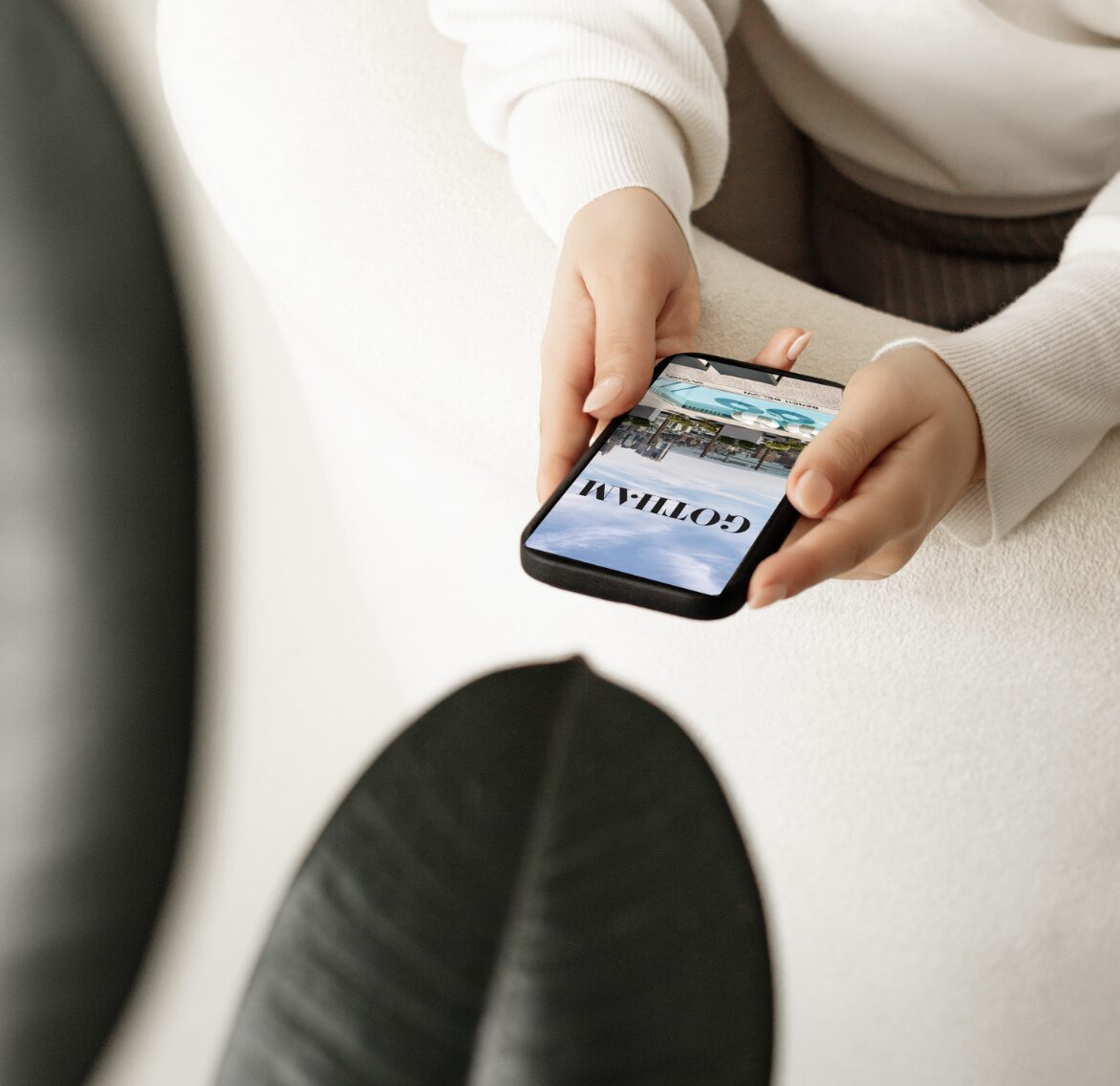 Person using the Gotham Living app on a smartphone