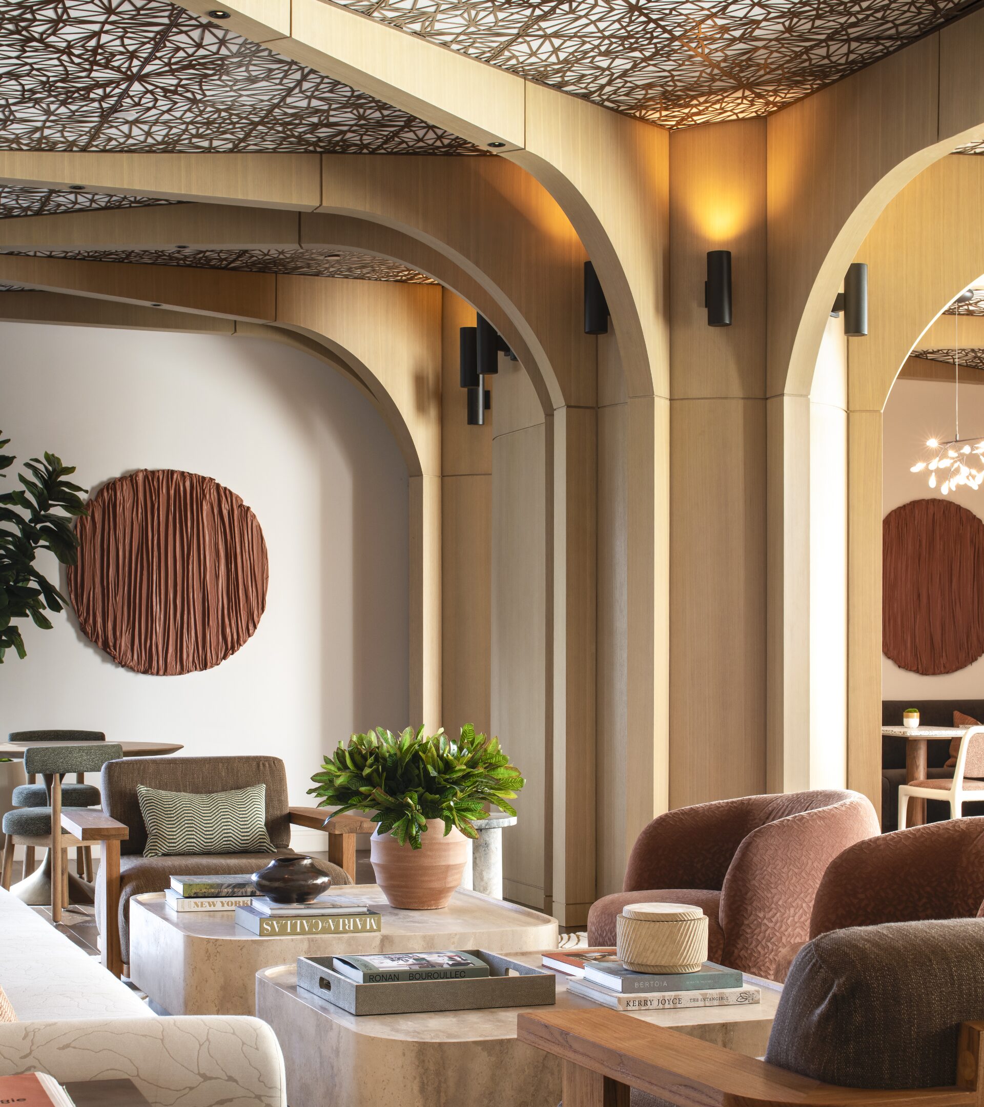 Arched resident lounge with warm wood finishes and curved seating