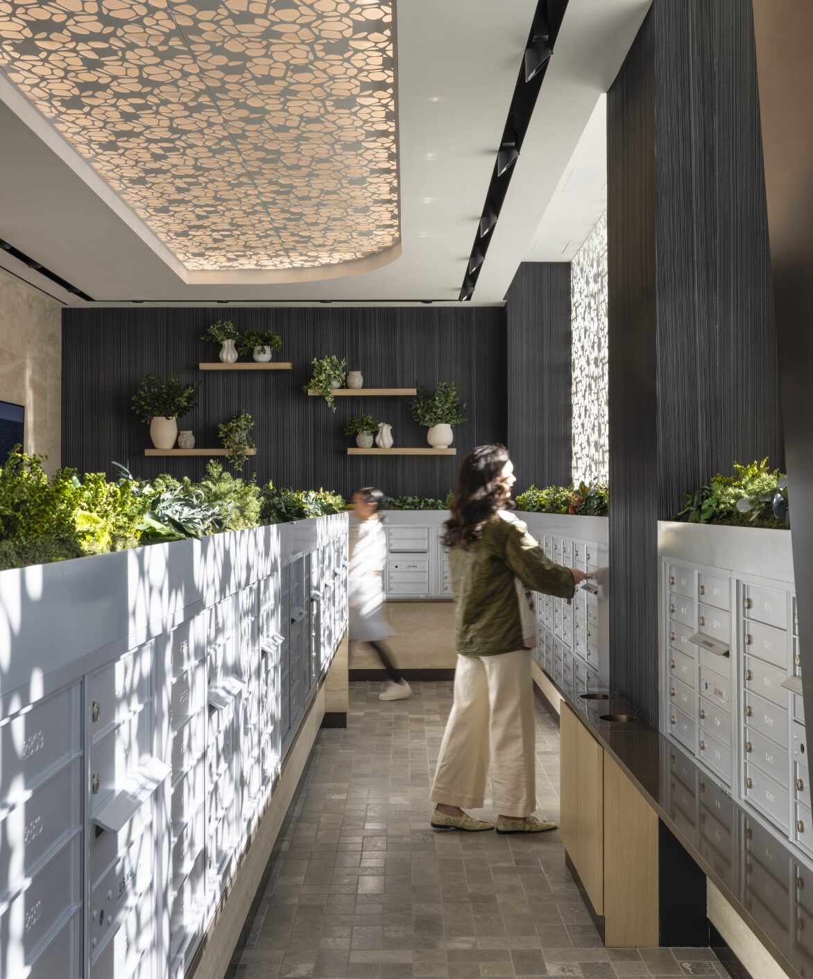 Marble reception desk beneath a patterned ceiling