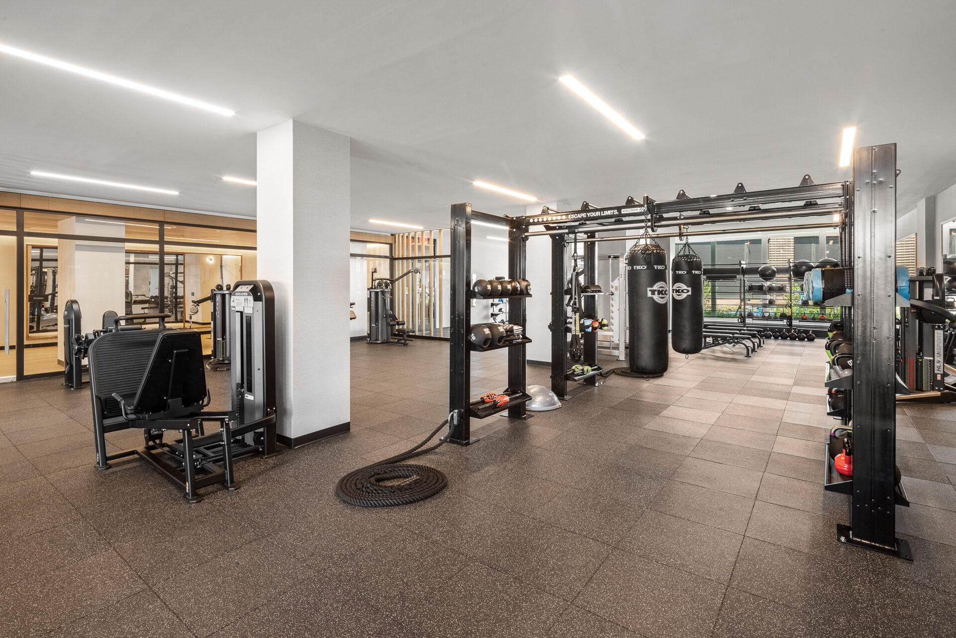 Fitness center at Gotham Point with strength-training equipment and punching bags