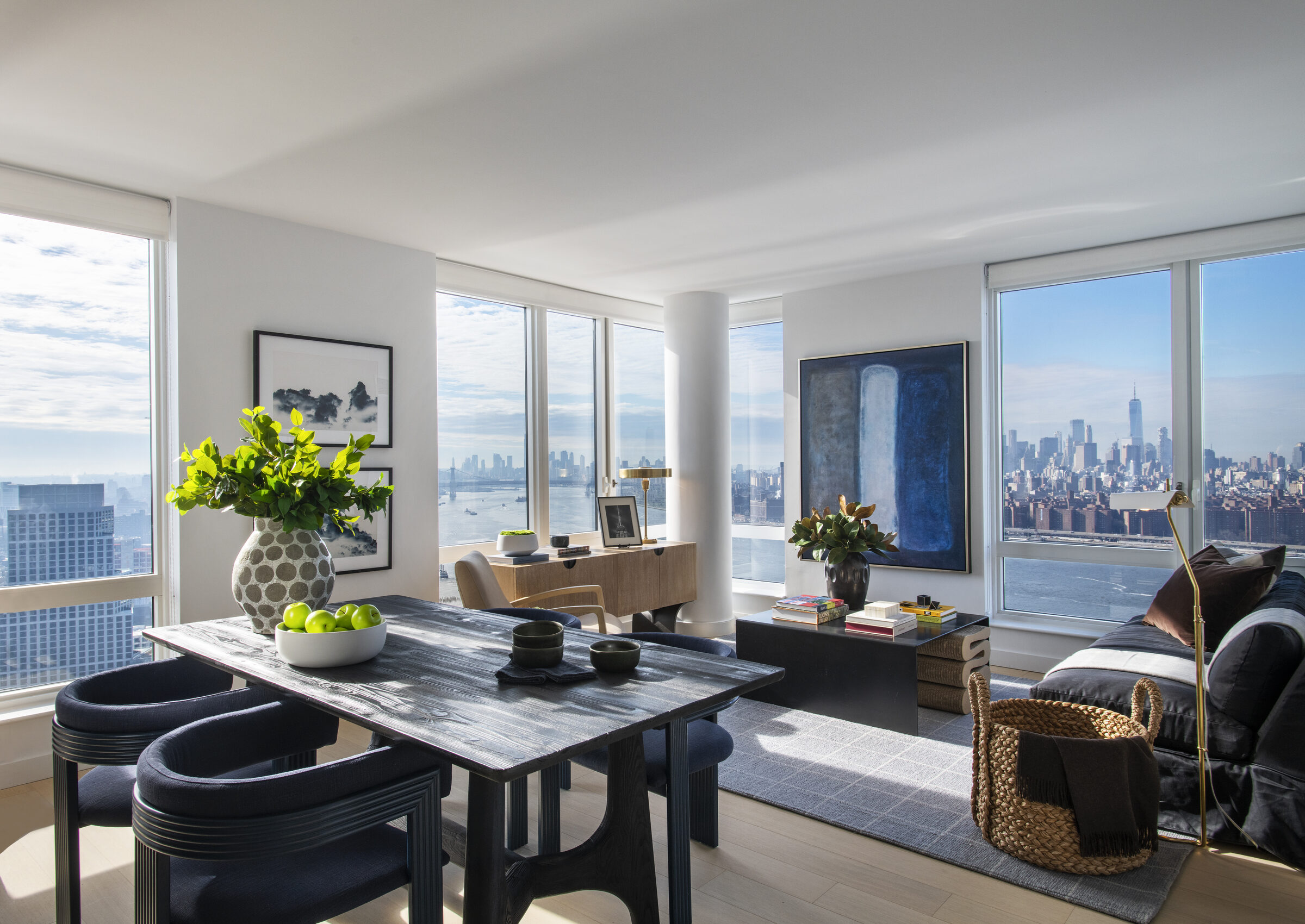 Open-plan living and dining room at Gotham Point with panoramic Manhattan views