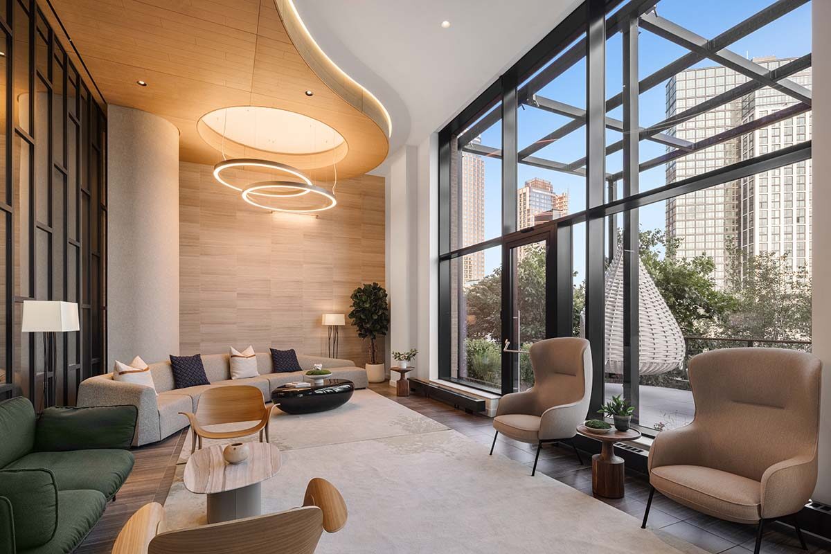 Double-height resident lounge at Gotham Point with floor-to-ceiling windows