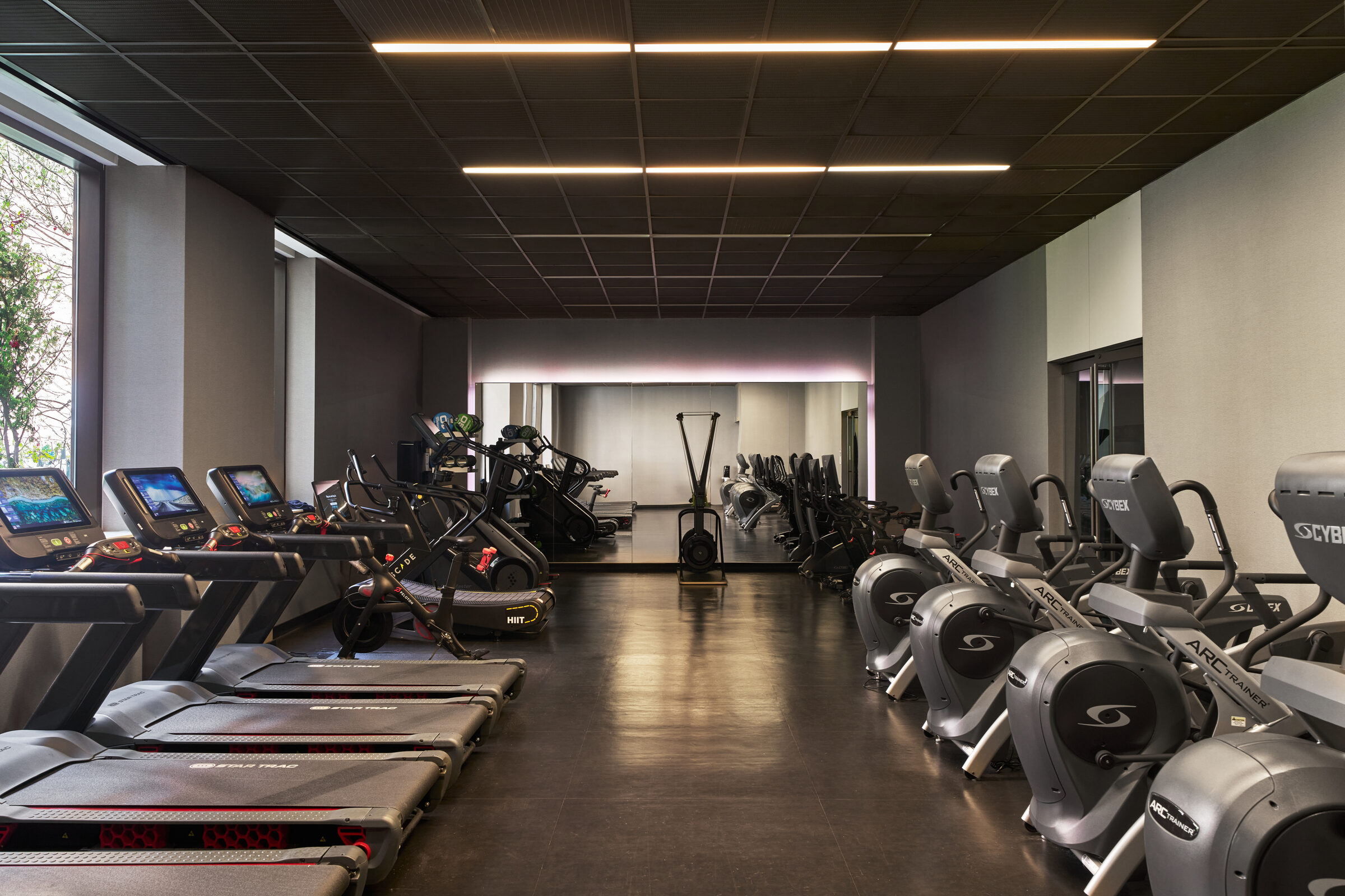 Fitness center at Gotham West with rows of cardio equipment