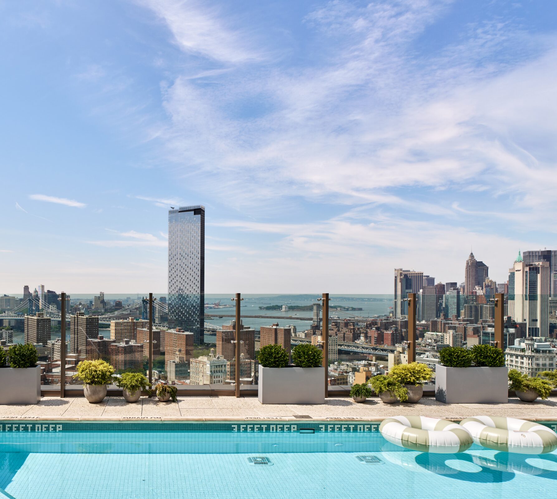 Rooftop pool at The Suffolk overlooking the Lower Manhattan skyline