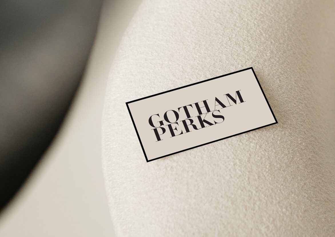 Gotham Perks card resting on a cream-colored cushion