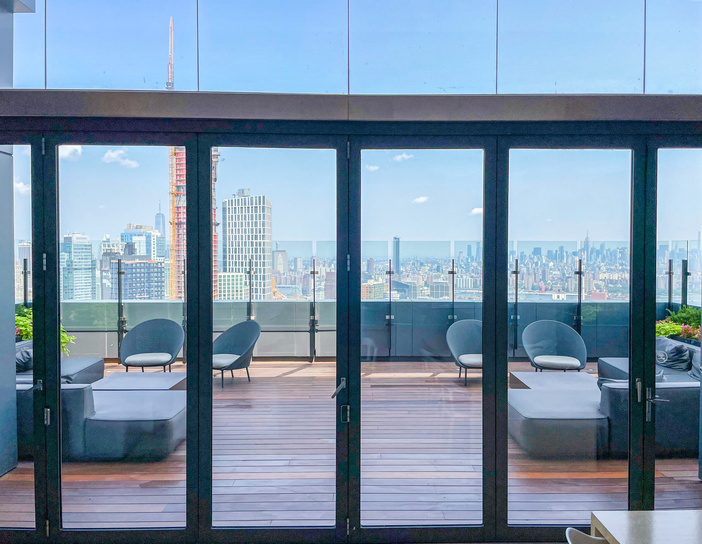 Rooftop terrace at The Ashland with lounge seating and skyline views