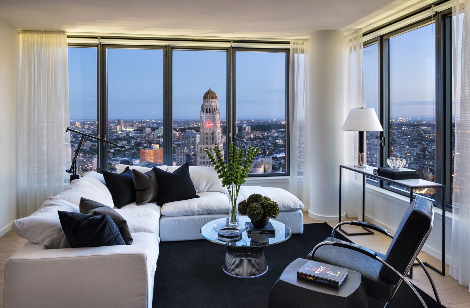 Corner living room at The Ashland with floor-to-ceiling windows and Brooklyn views