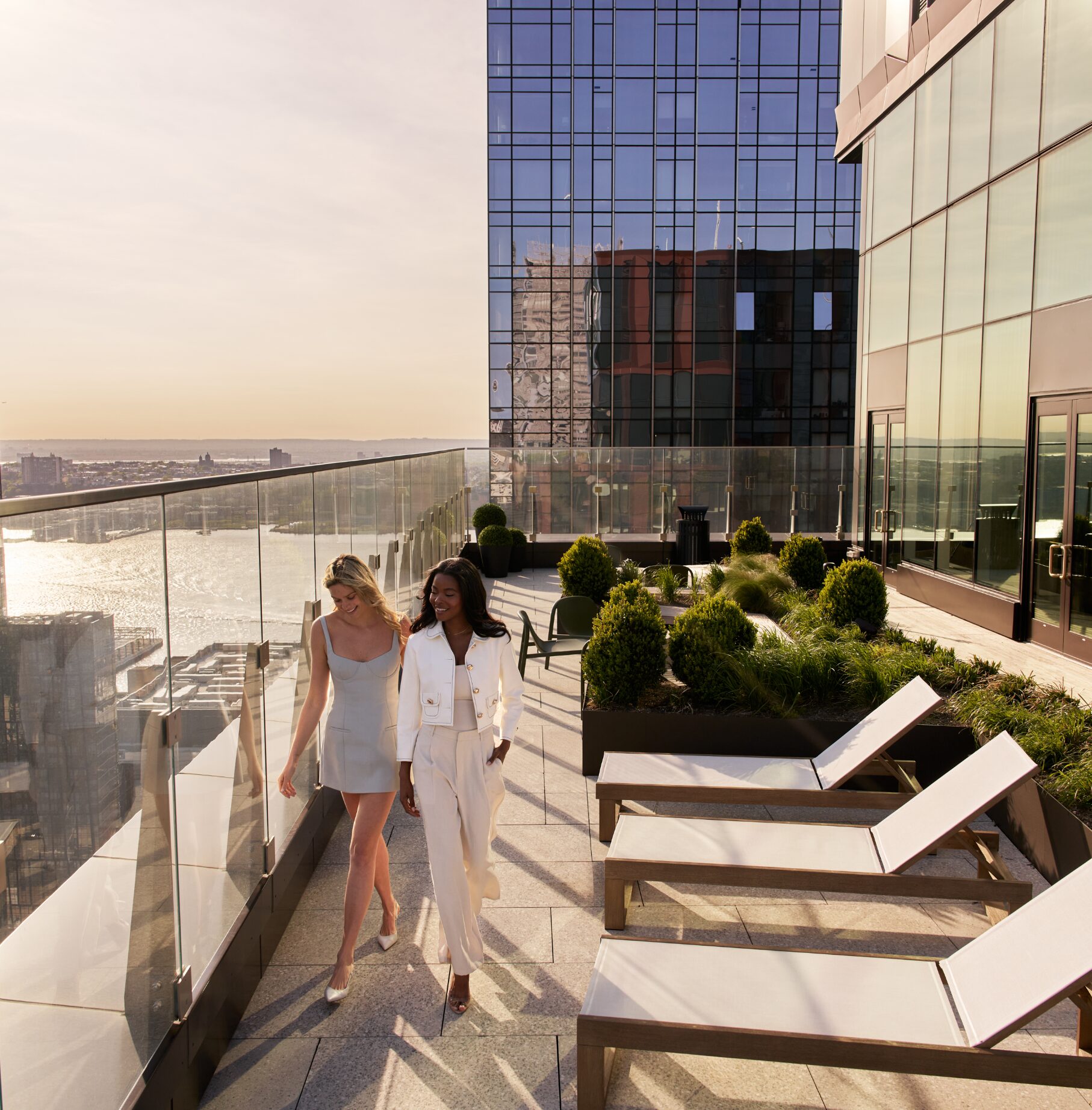 People standing on The Maybury rooftop terrace overlooking the Hudson River