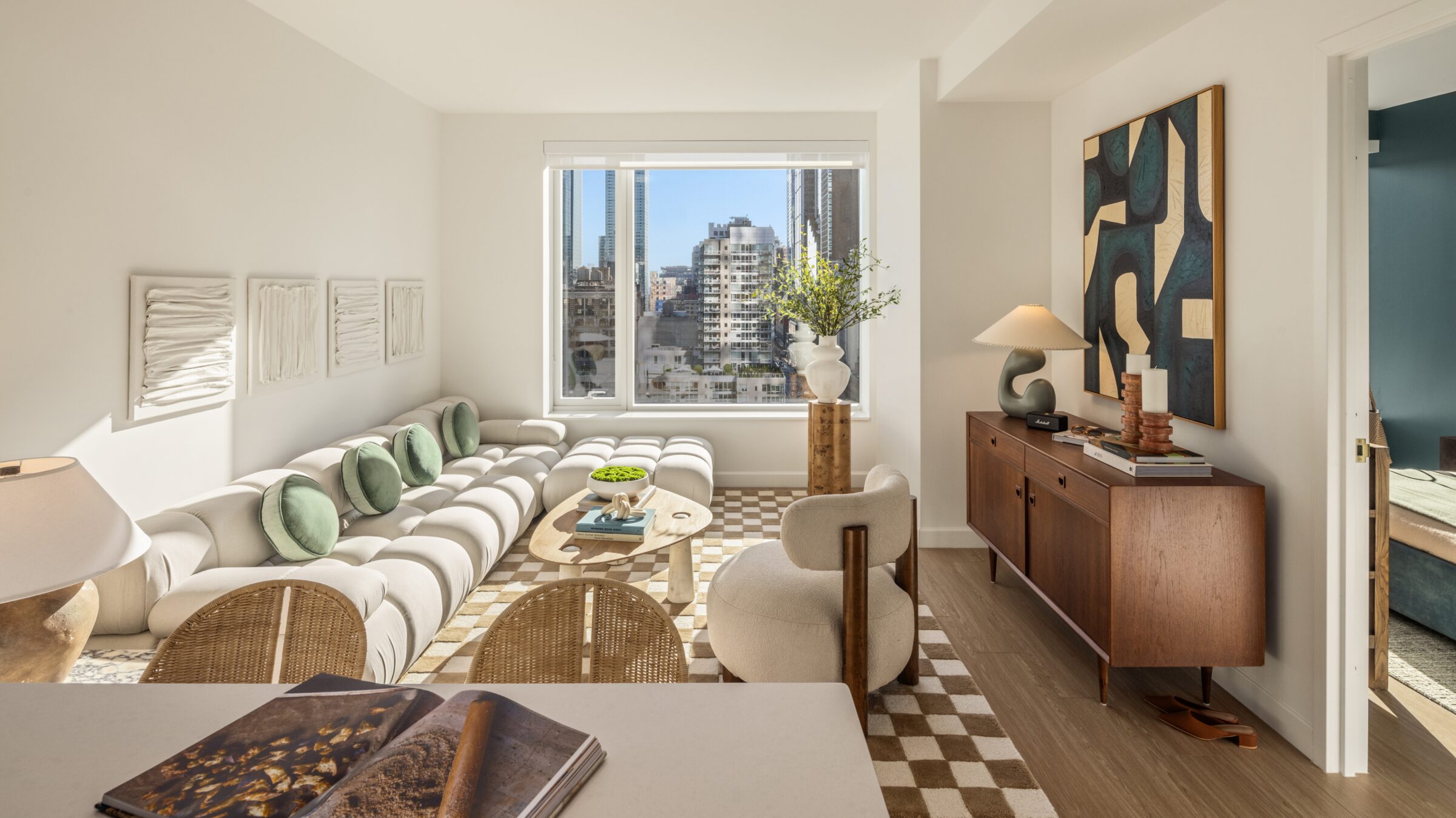 Sunlit living room at The Maybury with floor-to-ceiling windows and city views