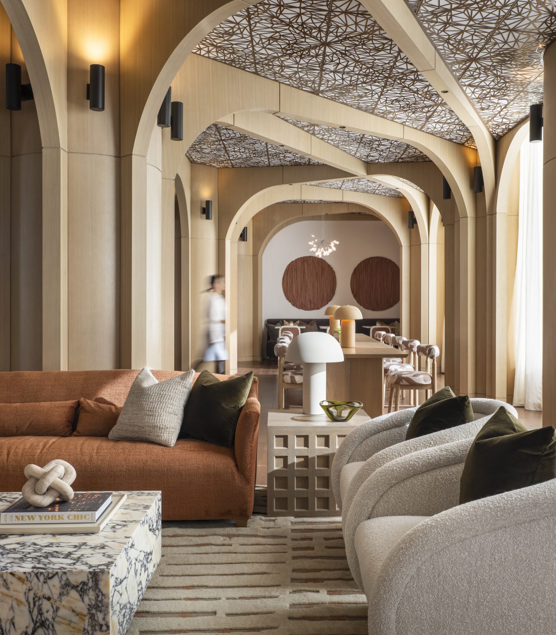 Arched lobby lounge at The Maybury with patterned ceilings and warm wood finishes