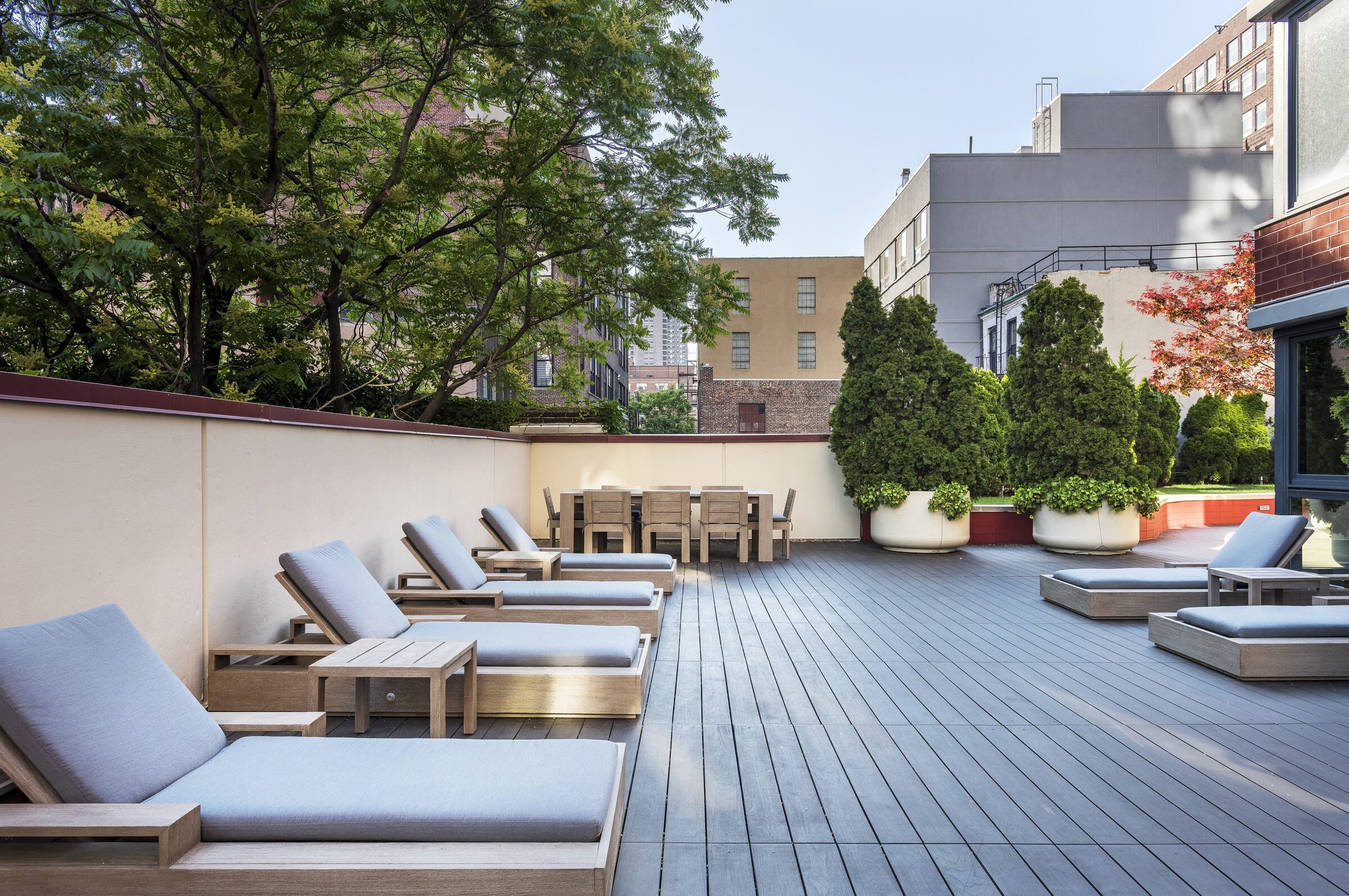 Landscaped sun deck at The Nicole with lounge chairs