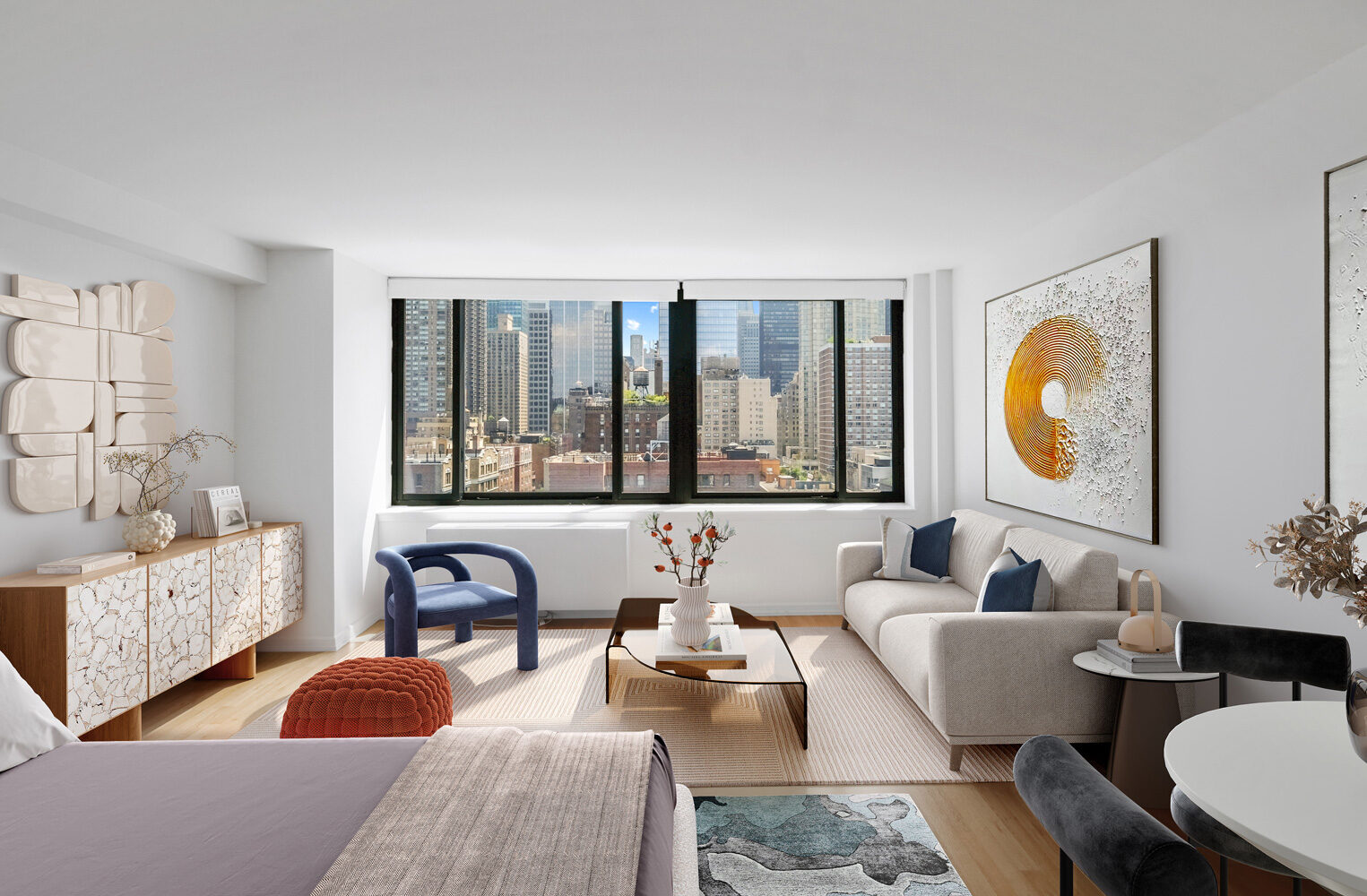 Sunlit studio residence at The Nicole with a large window and city views